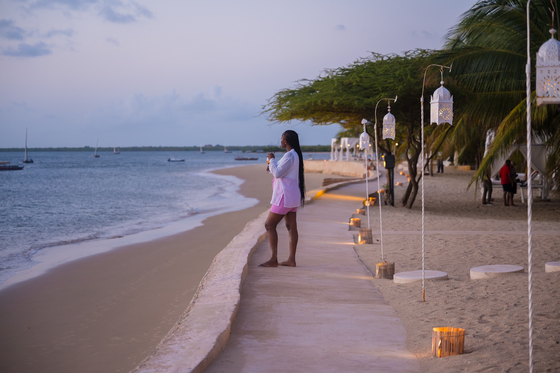 Lanterns line the beach at dusk as the dhows come home